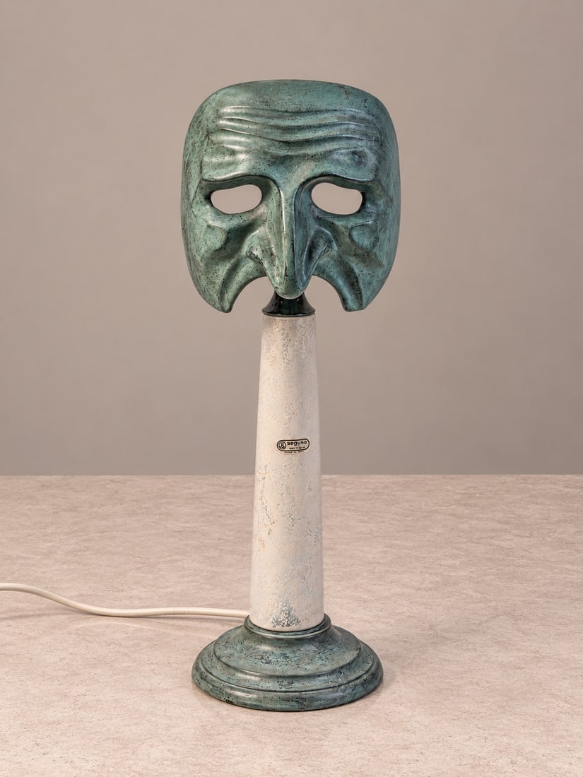 Elin Raaberg Nielsen (Danimarca), "LE MASCHERE" TABLE LAMP, circa 1970s: h cm 48 x d cm 15 Patinated bronze and Murano glass, depicting the Pantalone mask. Produced by Seguso Vetri d'Arte, Italy.