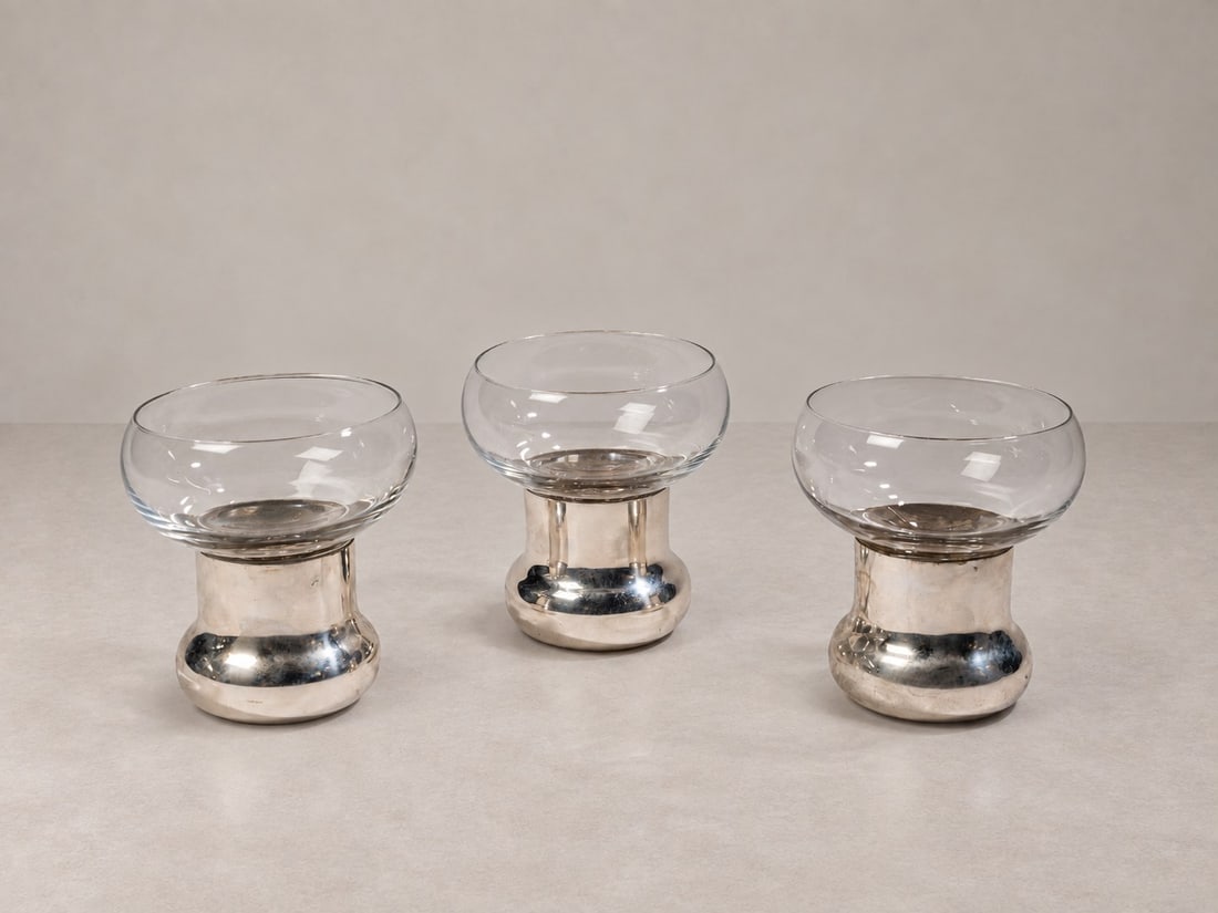 James Rivière (Amritsar 1949), GOBLETS, circa 1970s: h cm 11 x d cm 10 Set of three. Clear glass and 800 silver. Milanese silverwork of the 20th century, silversmith Antonio Francesco Cella, designed by James Rivière. Produced in Italy.