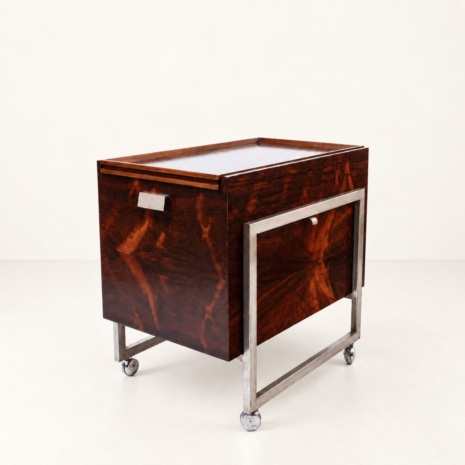 BAR CABINET, circa 1960s: l cm 45 x h cm 57 x p cm 70 Veneered wood, satin-finished metal, interior glass shelf, bottle compartment, pull-out serving tray and castors. South American production.