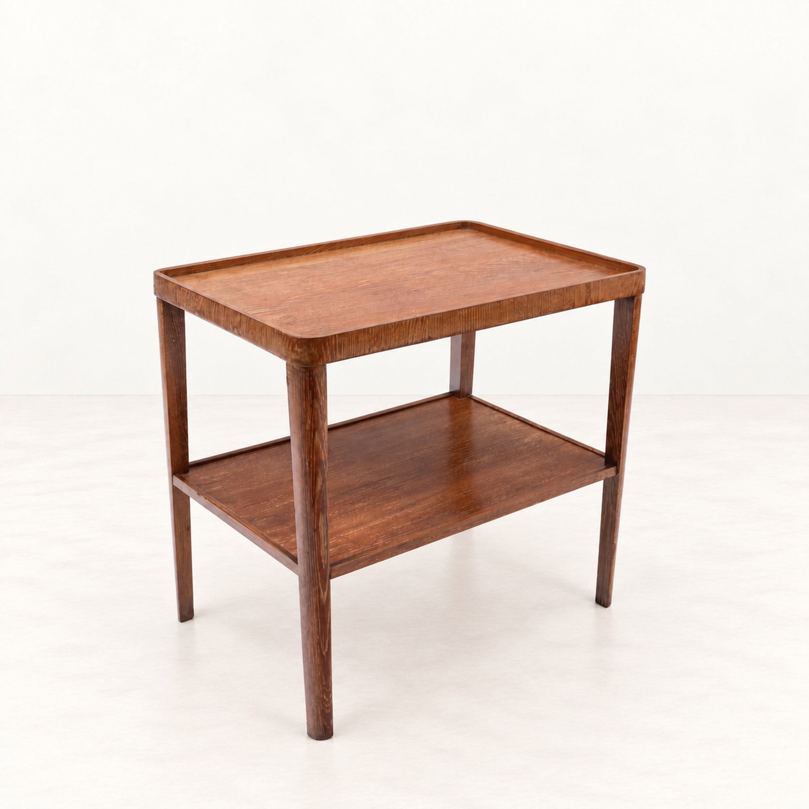 COMTE S.A., TWO-TIER TABLE, circa 1940s: l cm 64 x h cm 60 x w cm 44 Wood with two tiers. COMTE S.A. label to the underside. In the style of Jean-Michel Frank. Produced by Comte, Argentina.