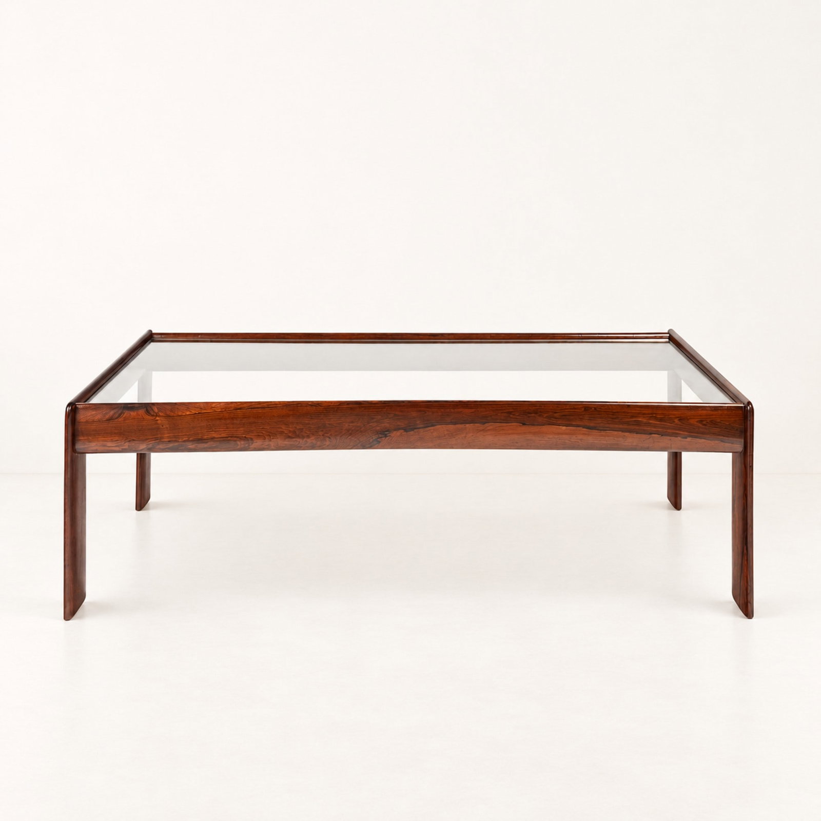 (Attribuibile a) Percival Lafer, LOW TABLE, circa 1960s: l cm 129 x h cm 40 x p cm 57 Wooden frame with glass top. Brazilian production.