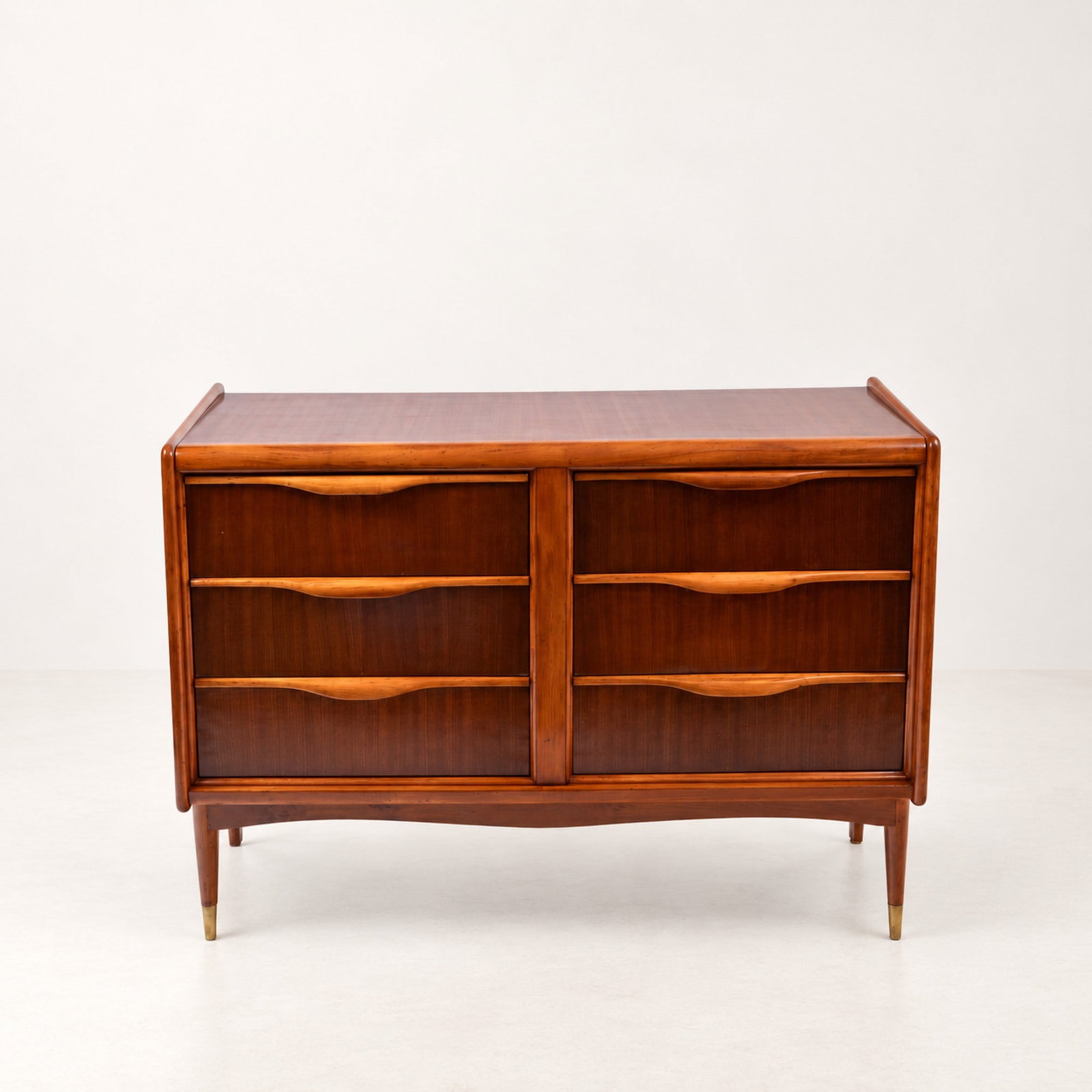 CHEST OF DRAWERS, circa 1960s: l cm 121 x h cm 90 x w cm 46 Veneered wood with six drawers and brass-capped feet. South American production.