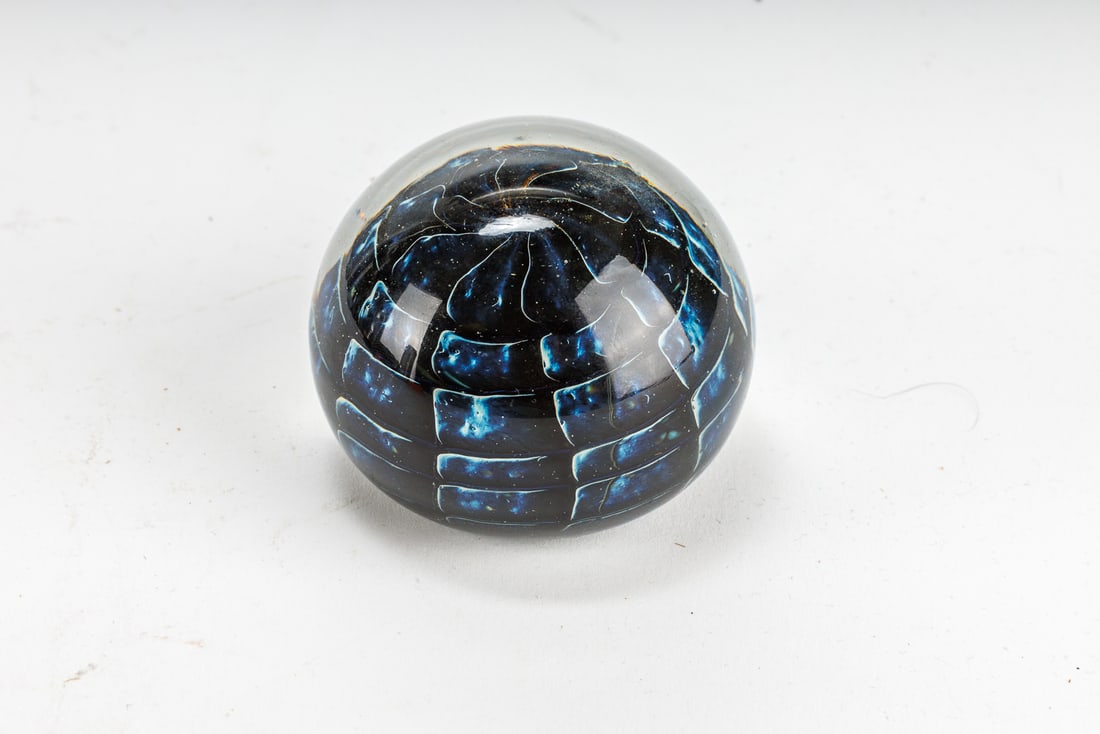 J. Ulrich Signed Art Glass Paperweight: Art glass paperweight with blue and black blocks inside the glass. Signed J. Ulrich 1983. Approximately 2.25 tall and 2.5 wide.