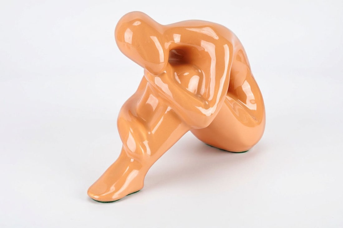 Vintage MCM Ceramic Sculpture - "Nude Female" by Jaru of California: This vintage, mid-century modern ceramic sculpture depicts a female figure posed into a contemplating or languished expression, her head resting against her knees. Stamped and dated to 1979 by Jaru