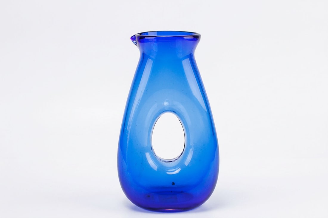 Stunning Mid Century Modern Blue Art Glass Pitcher.: Stunning Mid Century Modern Blue Art Glass Pitcher.? Featuring a donut hole center design.? Great for table top piece or vase.? See photos for details.