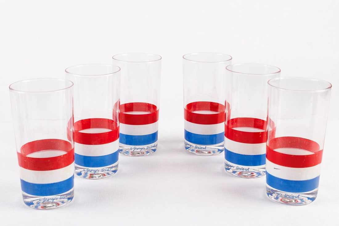 Set of 6 Georges Briard MCM Highball Glasses in Red, White, and Blue: By Georges Briard, this matched set of six mid-century modern highball glasses is decorated throughout with eye-catching stripes of red, white, and blue. Each glass exhibits the maker's signature