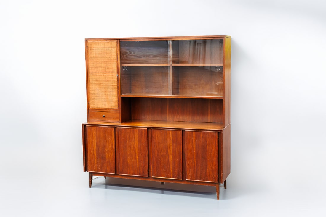 Vintage American of Martinsville MCM Walnut and Cane Credenza and Hutch: Crafted by noted designer Merton Gershun, this mid-century modern credenza and hutch duo by American of Martinsville showcases a classic, elegant form that is sure to compel in any living space. The