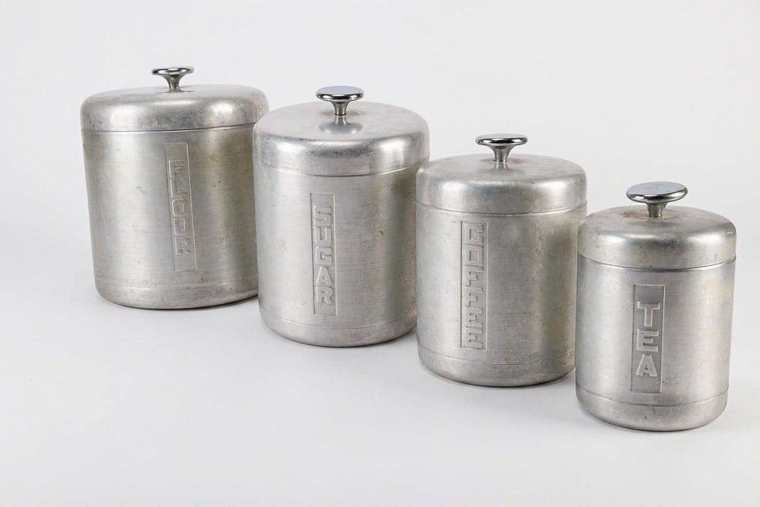 Vintage Century Aluminum Canister Set: Sugar, flour, tea, and coffee aluminum canisters. Surface wear consistent with age, the tea canister has a dent in the lid.?