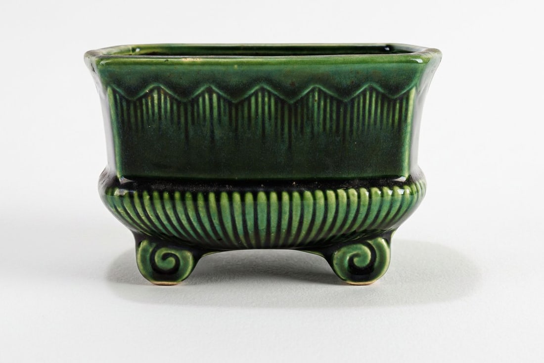 Vintage Art Deco Planter: Green drip glaze planter with triangular trim along the top, vertical ribbing, and scrolled feet. No major damage but crazing is prevalent on the whole piece, please see photos for more details.?