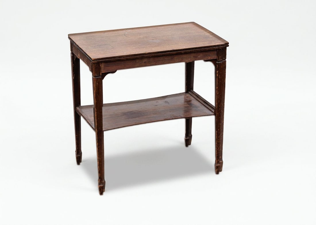 Vintage Accent Table with Lower Shelf: This small accent table is dated vintage and has been well-loved over the years, adding to its rustic charm. This table features a rectangular top and lower shelving unit that is supported by
