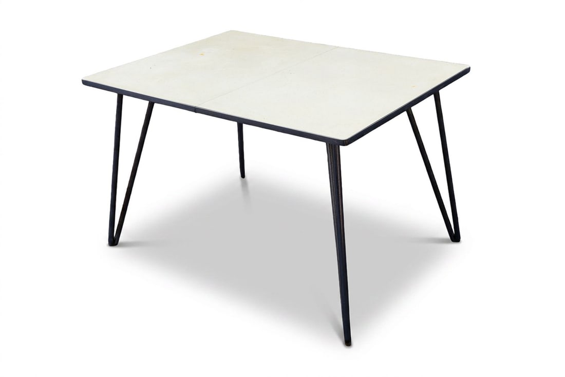Vintage MCM Yellow Formica Dining Table: Dated vintage, this mid-century modern dining table features a rectangular, yellow Formica top that is supported by minimalist hairpin legs. A single leaf is included with this table to accommodate