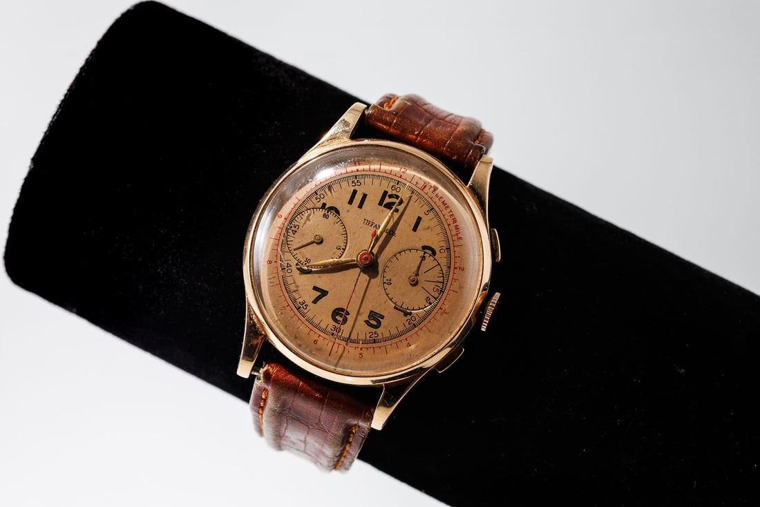 Vintage 18K Gold TIFFANY & Co. Men's Chronograph Watch with deBeer Wild Alligator Leather Band: Vintage 18K gold TIFANY & Co. chronograph watch with Alligator leather band. Champagne colored dial with gold "TIFFANY & Co." Winds and ticks, but is otherwise untested. The exterior of the back case