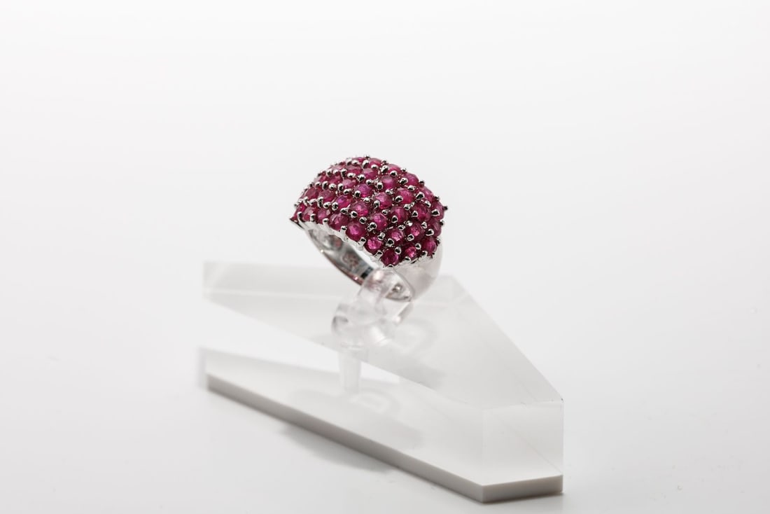 Sterling Silver Ruby Fashion Ring: The inside of the band is marked 925. The stones appear to be rubies, but are untested. The ring has minor wear consistent with age and use. Size 5.