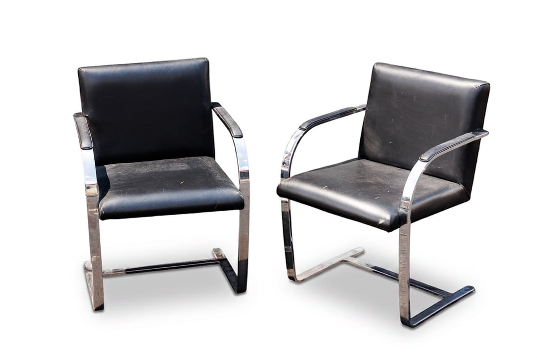Pair of Vintage MCM Brno Style Chairs: Modeled after the famed chairs by Mies van der Rohr for Knoll, these sleek reproduction Brno chairs feature a striking, cantilevered design that has been crafted from mirror-polished chrome flat