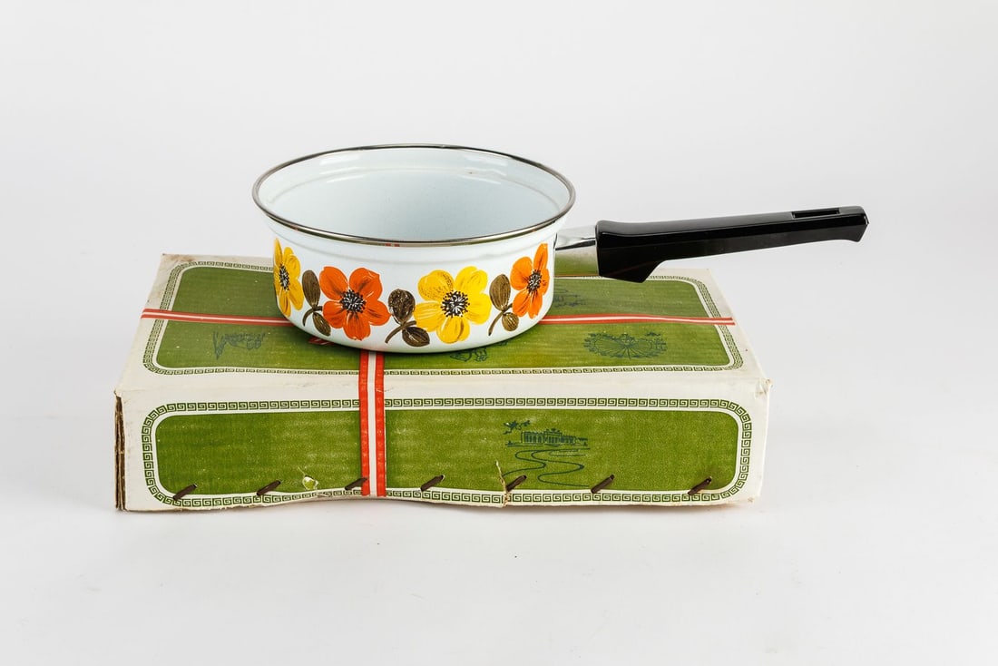 Vintage Austria Email Primavera Saucepan: Vintage mid-century 1 quart enamel saucepan with original box. The pan features a white background with decorative orange and yellow flowers.