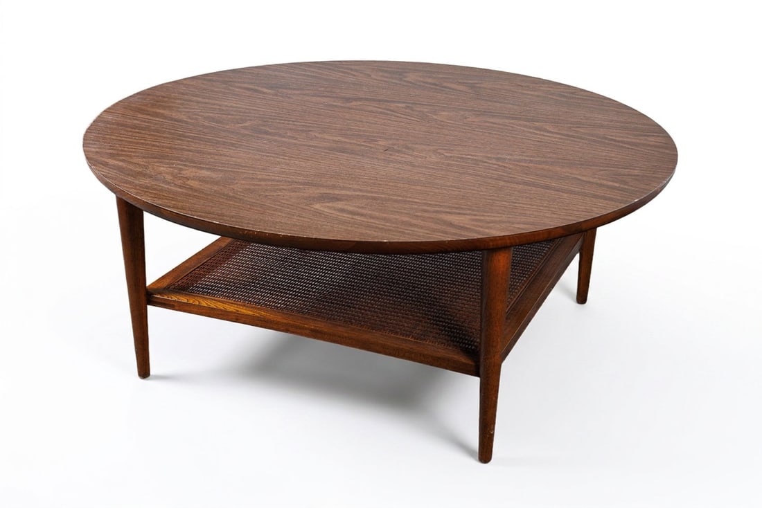 MCM Lane Reflection Round Coffee Table: Classic Mid-Century Modern round coffee table by Lane Furniture. Featuring a beautiful circular walnut wood grain top, a lower woven cane shelf, and supported by sleek, tapered legs. A fantastic addit