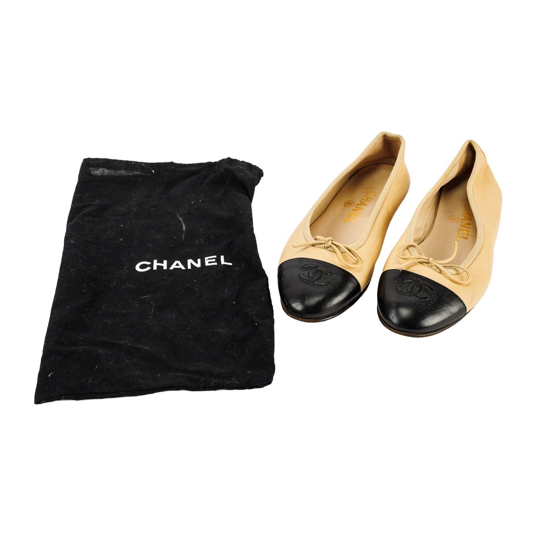 Chanel Ballet Flats size 6.5: Chanel two tone beige and black lambskin ballet flats size 37, US 6.5-7. There are a few small spots on the upper, and the bottom shows signs of wear.