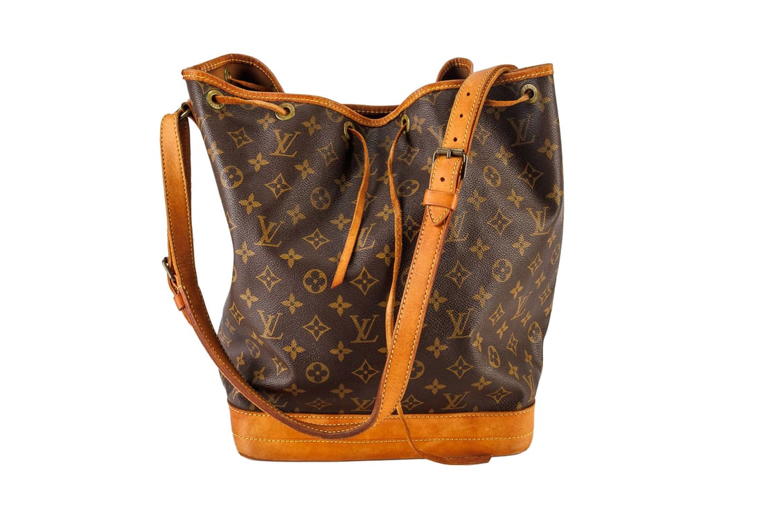 Louis Vuitton Monogram Noé GM Bucket Bag: Louis Vuitton monogram canvas Noe purse. There are scuffs and stains on the bottom, and two torn bottom corners. The rawhide drawstring shows heavy signs of wear. Includes dust bag, original shopping