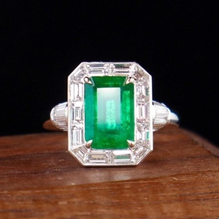 2.4ct Zambian Emerald 18Kt Gold Ring: An eye-catching emerald and diamond ring. 18Kt gold deluxe set with 2.4ct Zambian natural emerald and 1.72cts natural South African high quality diamonds. The central emerald has an enchanting full gr