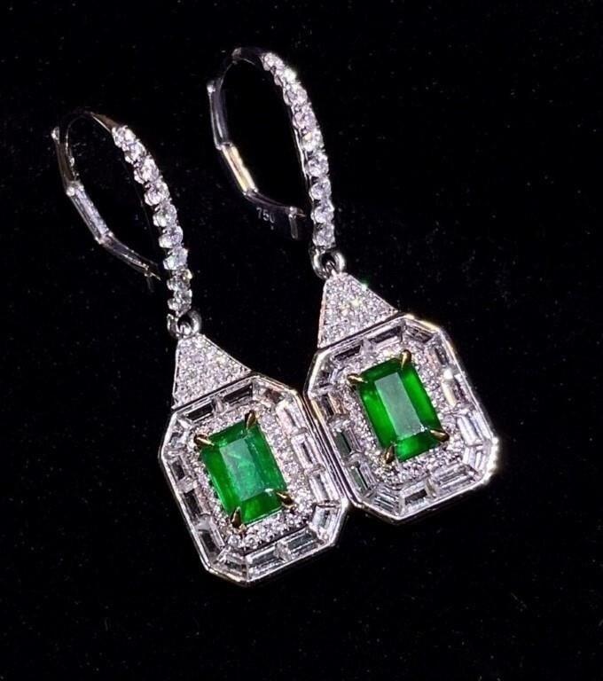 1.07cts Natural Emerald 18Kt Gold Earrings: An eye-catching emerald and diamond cluster earrings. 18Kt gold set with 1.07cts natural emeralds and 1.83cts natural South African high quality diamonds, The central emerald has an enchanting Vivid g