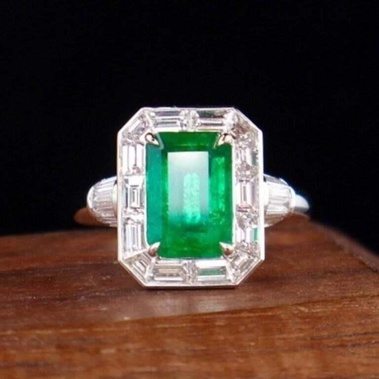 2.4ct Zambian Emerald 18K Gold Ring: A eye-catching emerald and diamond ring. 18K gold deluxe set with 2.4ct Zambian natural emerald and 1.7cts natural South African high-quality diamonds. The central emerald has an enchanting full green