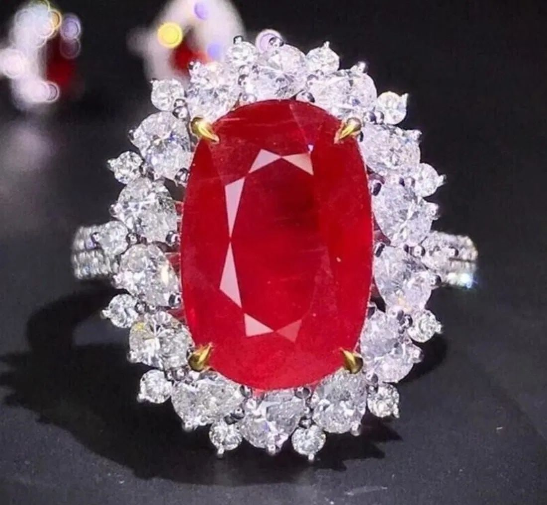 12.8ct Mozambican Ruby Ring 18k gold: 18k gold luxuriously inlaid with 12.8ct Mozambican natural ruby and 5.5ct natural diamonds. Bright-coloured, crystal clean, good clarity. Oval-cut. Excellent cutting. International certified natural r