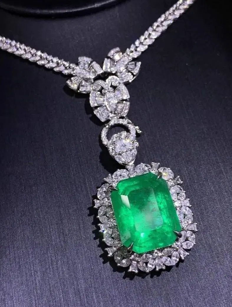 40.8ct Colombian Emerald 18Kt Gold Pendant: 18Kt gold set with 40.8ct Colombian natural emerald and 8.82ct natural South African high quality diamonds. Crystal-clear, clean and transparent, emerald green, excellent cut. Overall condition is