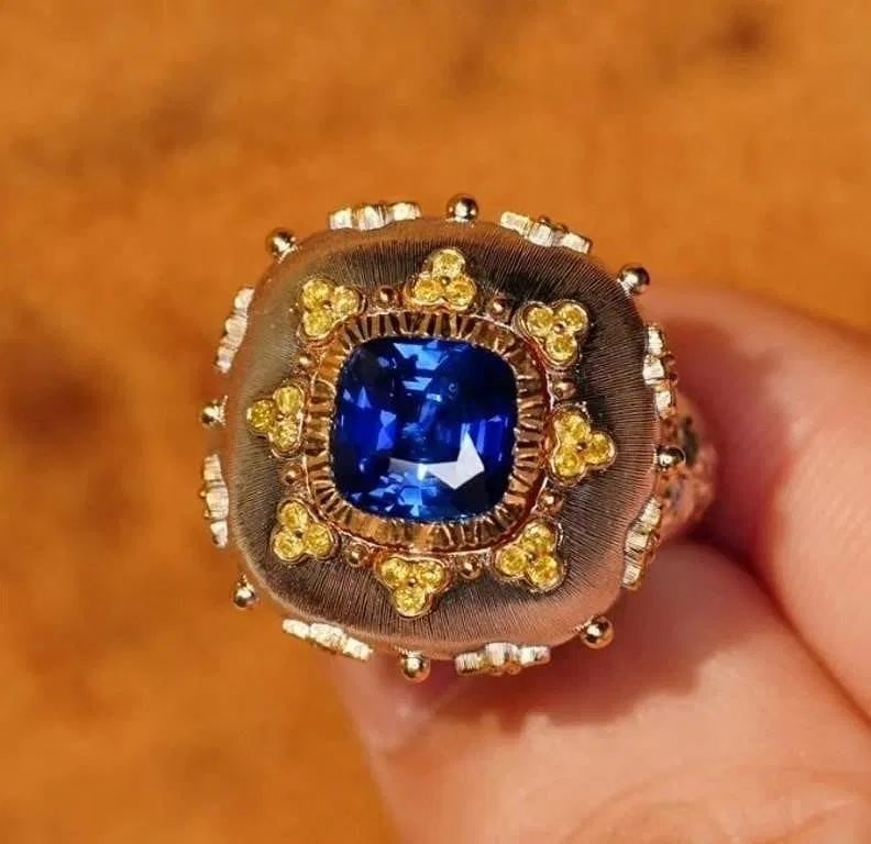 2.4ct Royal Blue Sapphire 18Kt Gold Ring: 18Kt gold set with 2.4ct natural royal blue sapphire and natural yellow diamonds. Crystal-clear, full color, good color. Gorgeous design, retro style, extremely good wearing effect. Overall condition