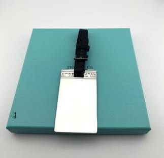 Tiffany & Co. Sterling Silver and Leather Atlas Pattern Luggage Tag: Tiffany & Co. Sterling Silver and Leather Atlas Pattern Luggage Tag. Comes with Tiffany and Co Box. Length of tag 2 7/8 inches. Weight 41 grams