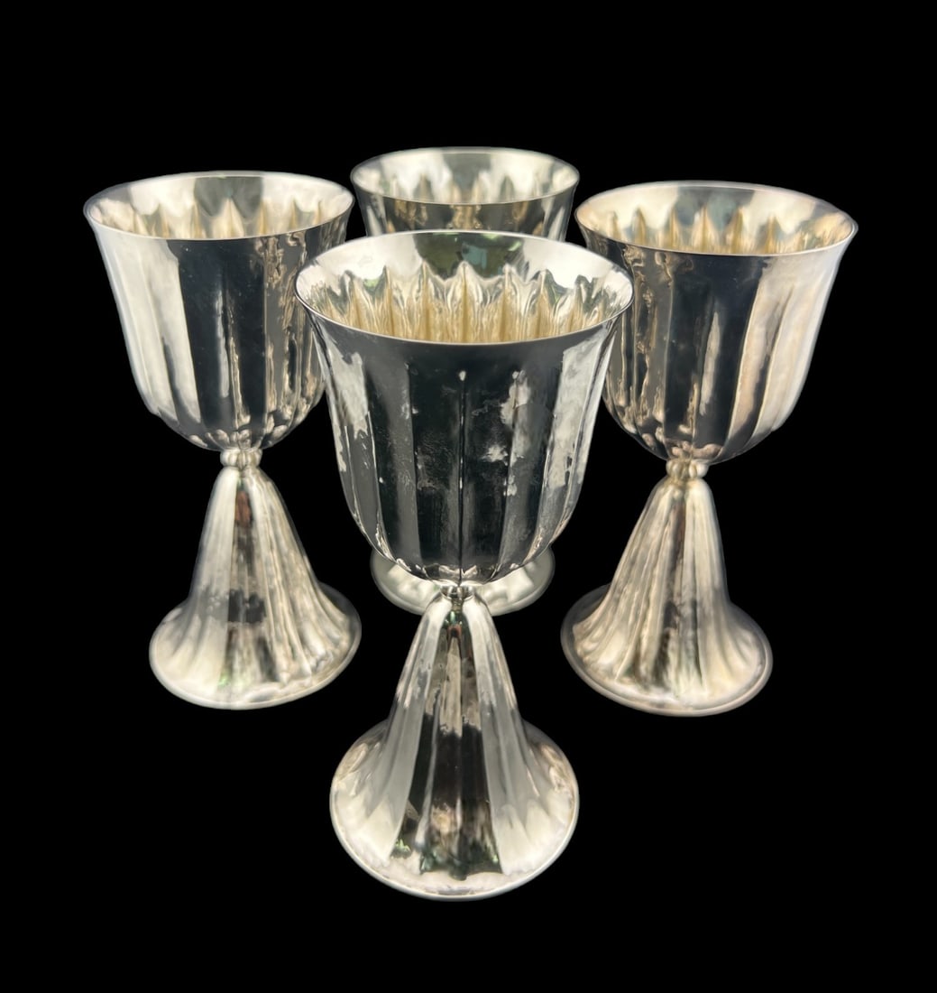 (Lot of 4) 1950 Buccellati Hammered Goblet: Italy, post 1950, elegant fluted form with conforming spreading base and hammered finish, marked to underside rim. Total weight is 652 grams. Height 6.25” diameter 3”.