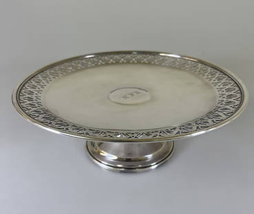 Tiffany & Co. Sterling Cake Plate: With pierced foliate rim on tapering support. 3 1/2in (9cm) h. 9 1/2in. (24cm) d. Monogrammed 'E.C.K.', 503.9 grams