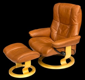 Ekornes Stressless lounge chair and ottoman, executed in brown leather