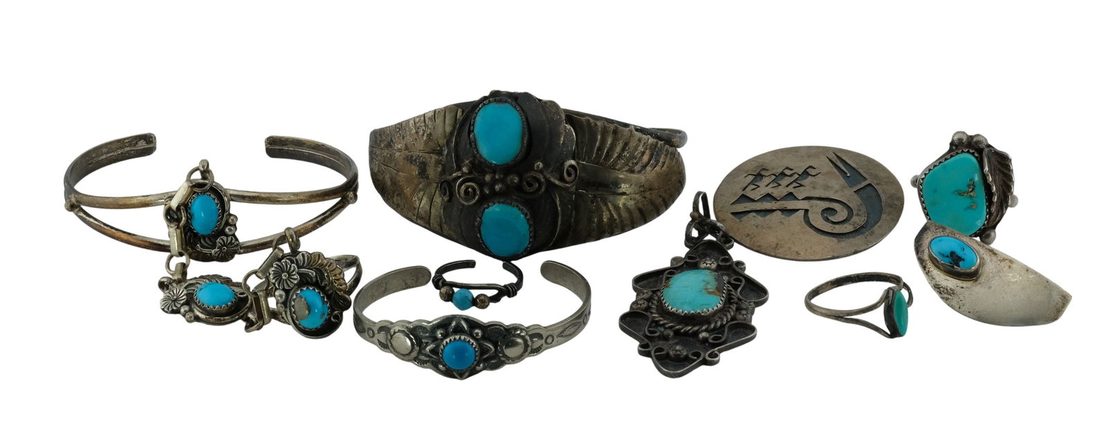 Collection of Native American Turquoise and Sterling Silver Jewelry: Collection of Native American Turquoise and Sterling Silver Jewelry. Include 3 cuff bracelets, 2 pendants, 4 rings, a brooch and one earring. j/m