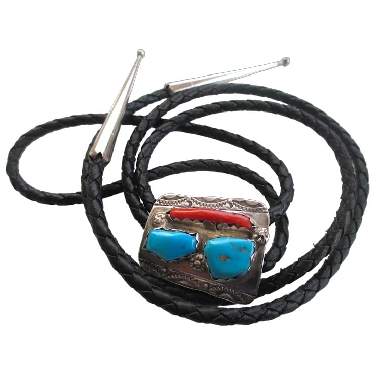 Vintage Billy and Nettie Nastacio Zuni Sterling Silver Turquoise and Coral Bolo Tie: Billy and Nettie Nastacio Zuni 925 Silver Turquoise /Coral Bolo Tie. The artist hallmark Billy and Nettie Nastacio. The bolo has two Turquoise nugget stones with one l coral. The cord is leather and h