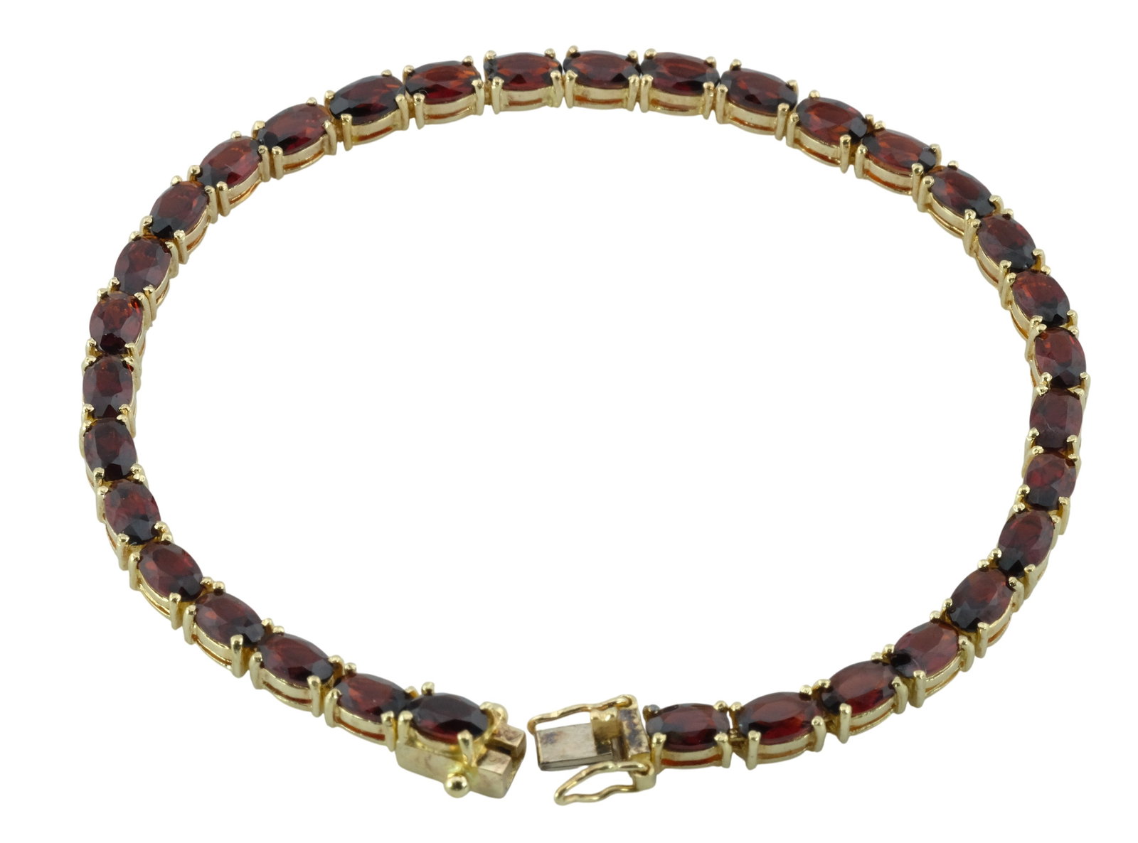 14k Garnet Tennis Bracelet: 14k Yellow Gold Garnet Tennis Bracelet. Size 7"
