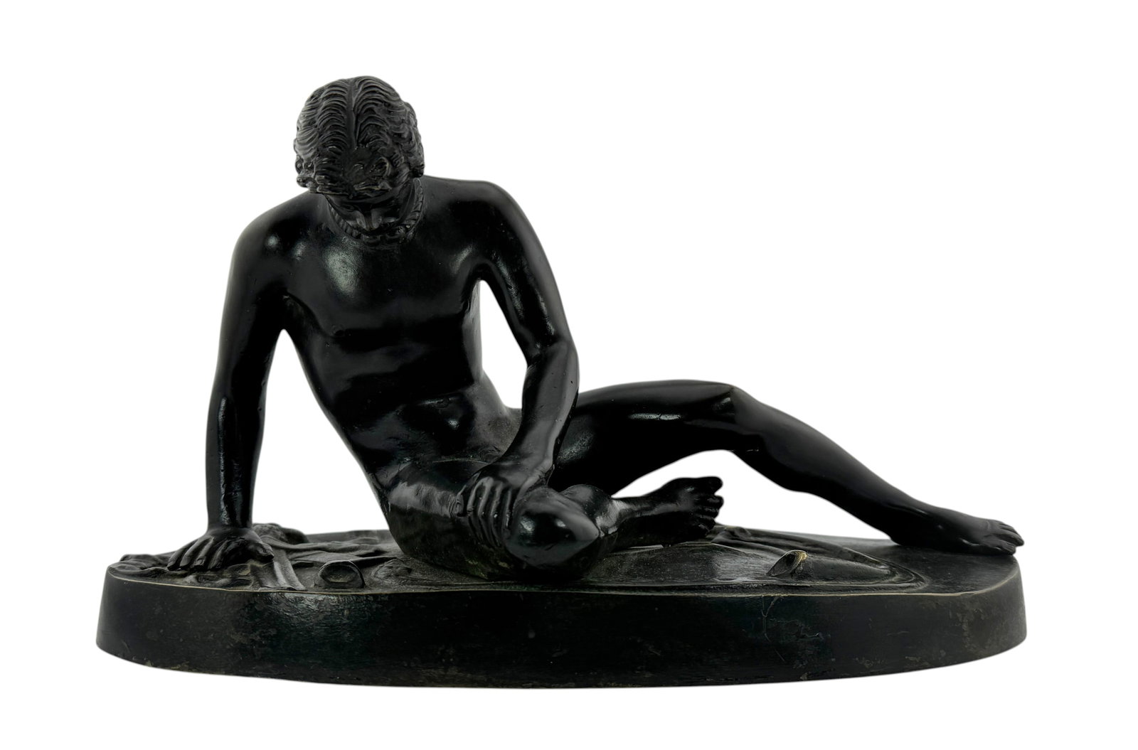 A bronze sculpture in the manner of the "The Dying Gaul": The sculpture, after the ancient Roman marble, depicts a wounded Galatian Celt with a Celtic torc around his neck and a sword and trumpet on the surrounding ground. Unmarked. Dimension 11" x 5" x 6"
