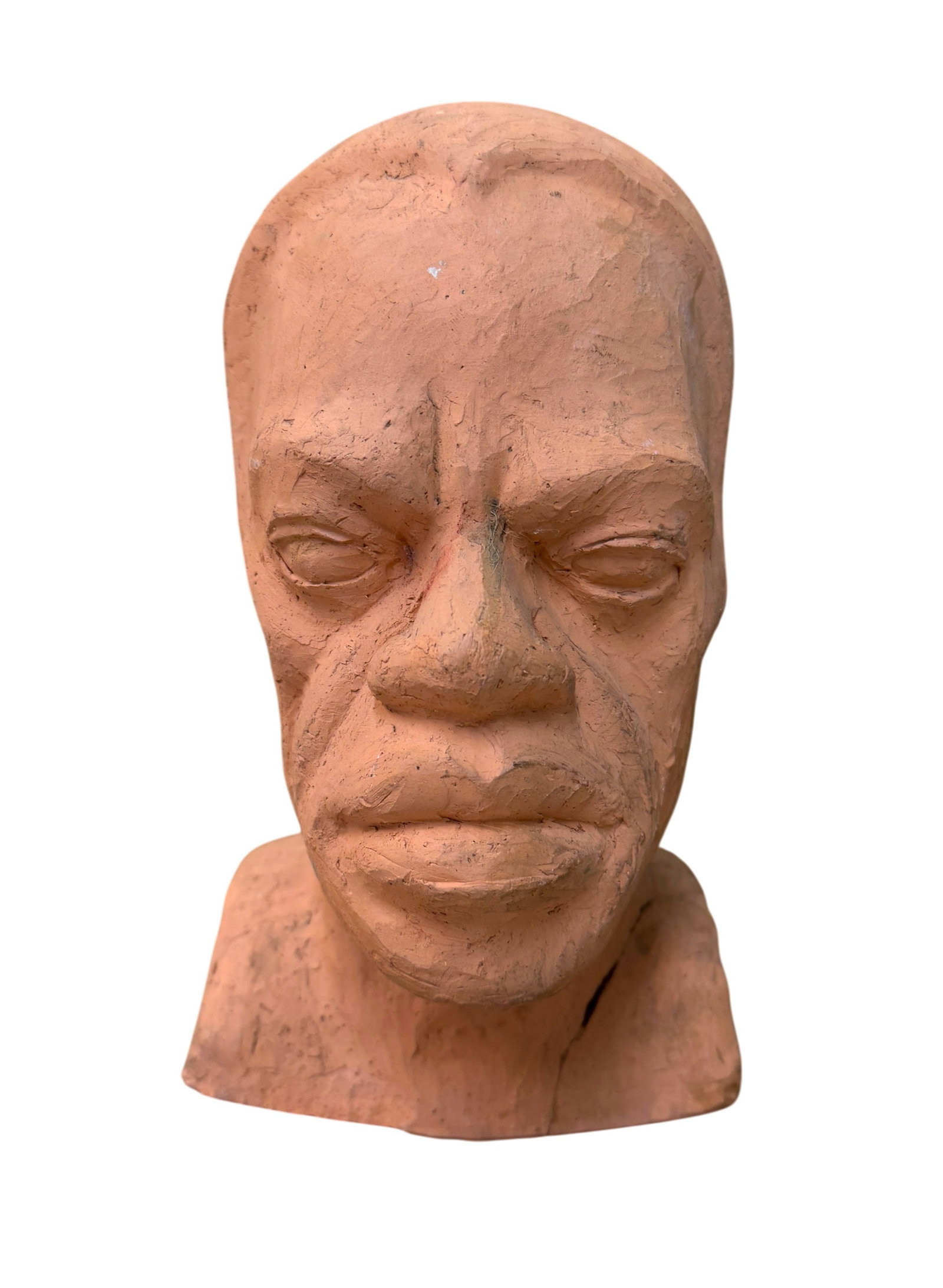 A Vintage Terracotta-Colored Bust of a Man: A Vintage Terracotta-Colored Bust of a Man. Signed on right side "Cristy B." Dimension 10" x 6" x 7." Condition: Repair on left corner