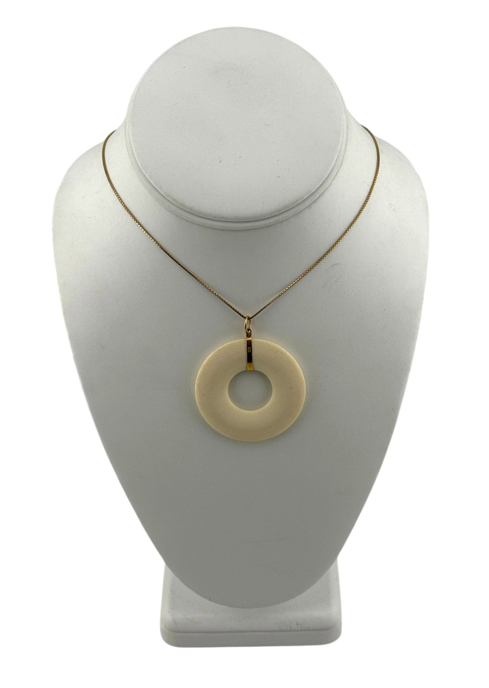 Vintage 14Kt Gold Donut Shaped Bone Carved Pendant Necklace with 9Kt Bail: Vintage 14Kt Gold Donut Shaped Bone Carved Pendant Necklace with 9Kt Bail. Necklace marked "14K" and necklace bail marked "9k." Length of necklace 19." Total weight 10.5 grams