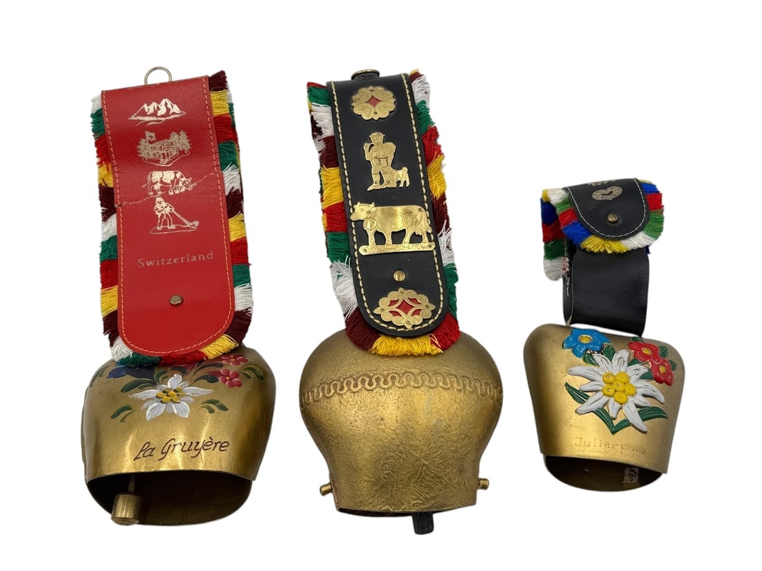 (Lot of 3) Swiss Vintage Brass Ornamental Cowbells with Leather Multicolor Fringe: (Lot of 3) Swiss Vintage Brass Ornamental Cowbells with Leather Multicolor Fringe. Condition: Leather has cracks and wear. Largest bell 11." A/R