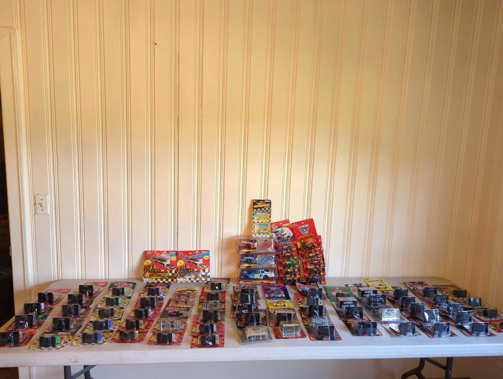Over 60 NASCAR Racing Champions Die Casts and More: Several die cast cars, team transporters and including 1:64 scale die cast cars, see photos for all included.