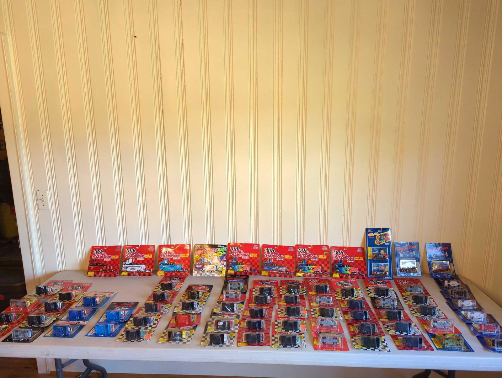 More than 70 NASCAR Racing Champions Items: Several NASCAR racing team transporters and die cast cars, see photos for all included.
