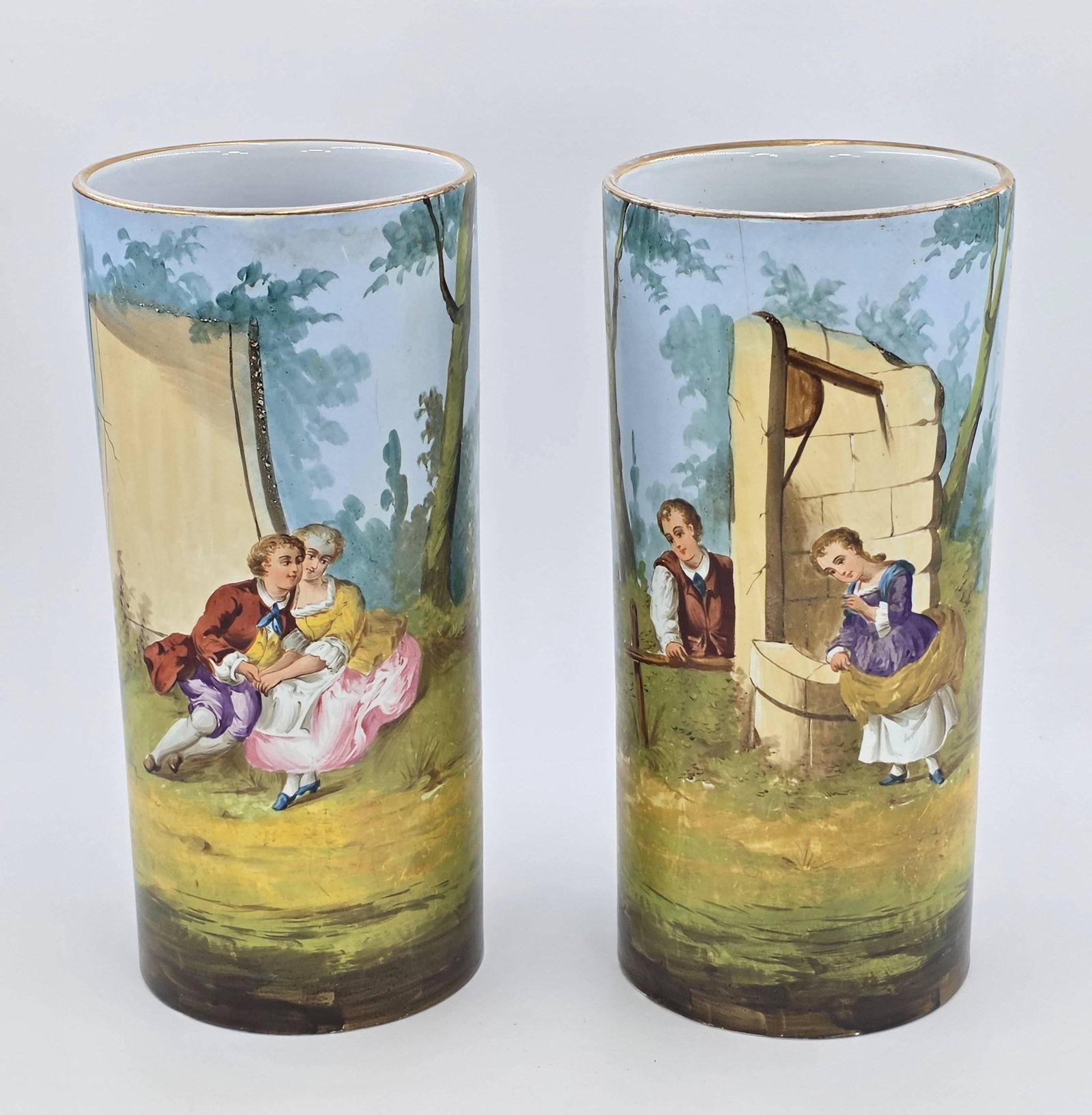 Pair of Sevres Style or Dresden Style Cylinder Vases Hand Painted, INV. 1194: Featuring courting scenes. Approx. height of both 10 1/4". Both with drilled holes to the bottom.