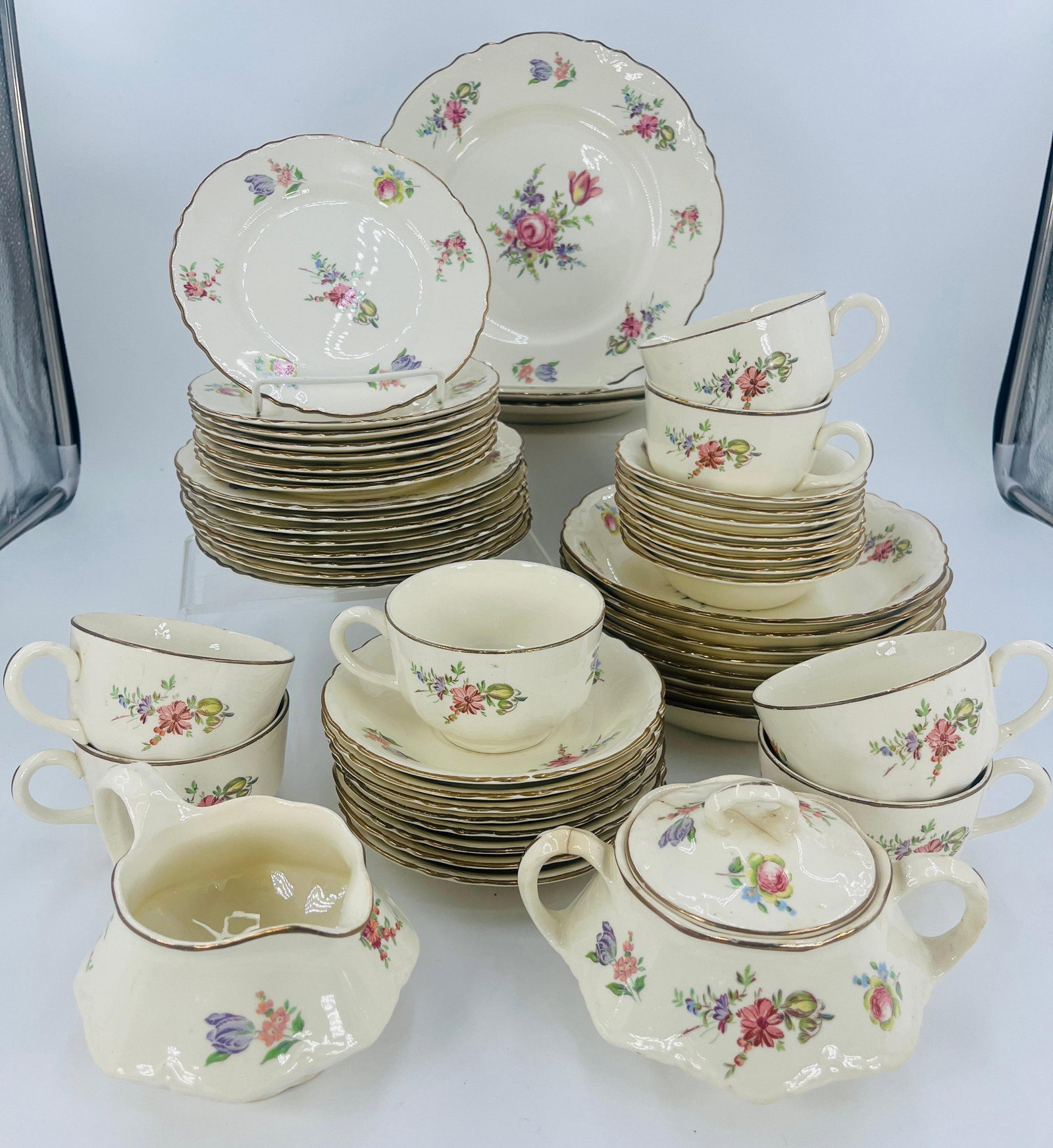 Homer Laughlin Priscilla Pattern Servingware Set, INV. 1120: Includes 3 large plates, 8 medium plates, 8 small plates, 8 large bowls, 8 small bowls, 8 saucers, 7 cups, 1 creamer, 1 sugar bowl with lid. Approx. dia. of large plate 9 1/8", large bowl 8". With cra