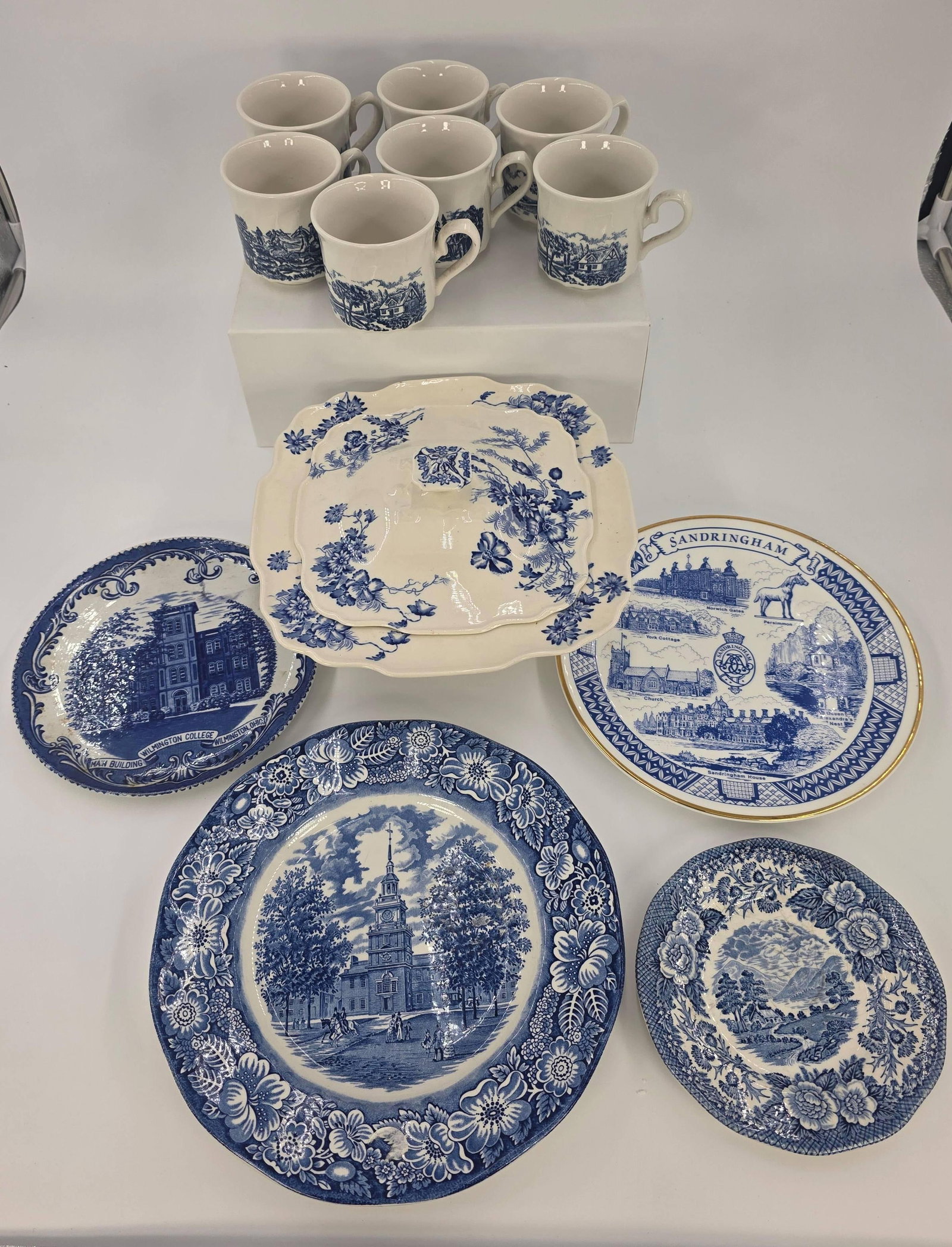 13 English Blue and White Assorted Items, INV. 1035: Including 7 mugs of 2 different patterns. 9 5/8" dia. of largest plate. With markings. With small chip to lid.