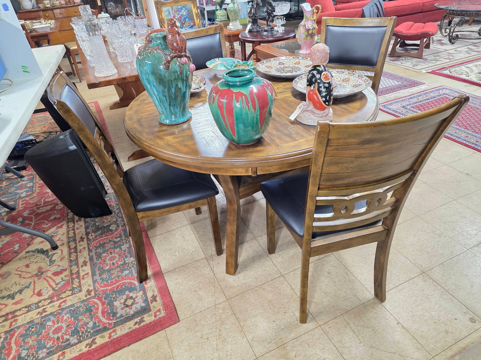New Classic Furniture Designer Round Table and Four Chairs, INV. 3026: Not including contents. Each chair approx. 39 x 18 x 18.5 inches. Table approx. 30.5 x 47.5 x 47.5 inches.