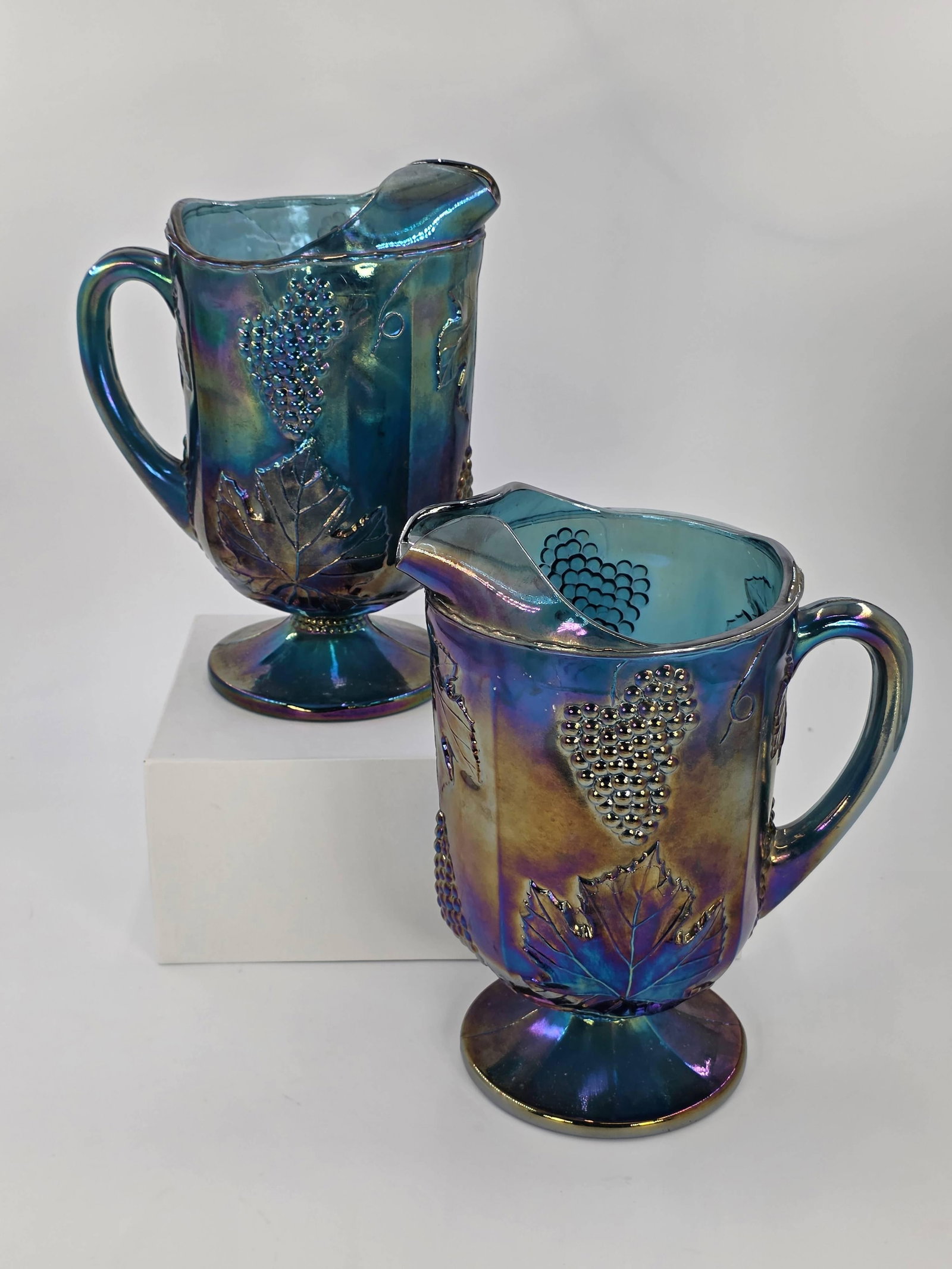 2 Indiana Glass Iridescent Blue Carnival Glass Footed Pitchers, Vintage, INV. 1038: 10 1/2" height of tallest pitcher.