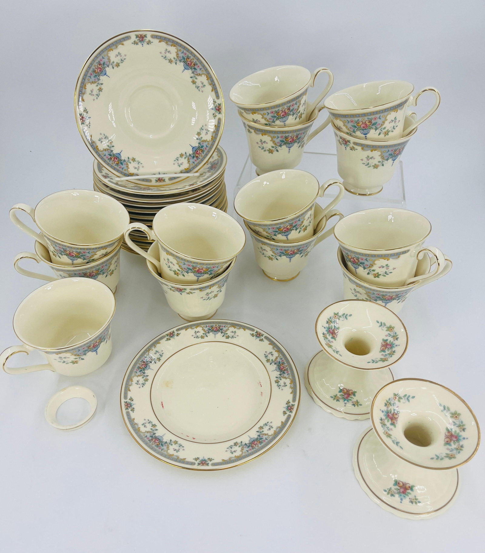 Royal Doulton The Romance Collection Juliet Pattern Servingware, INV. 1127: Includes 1 small plate, 14 saucers, 13 cups, 2 candlestick holders. Approx. dia. of plate 6 5/8", dia. of saucer 6 1/8". One mug with broken foot. With marking.