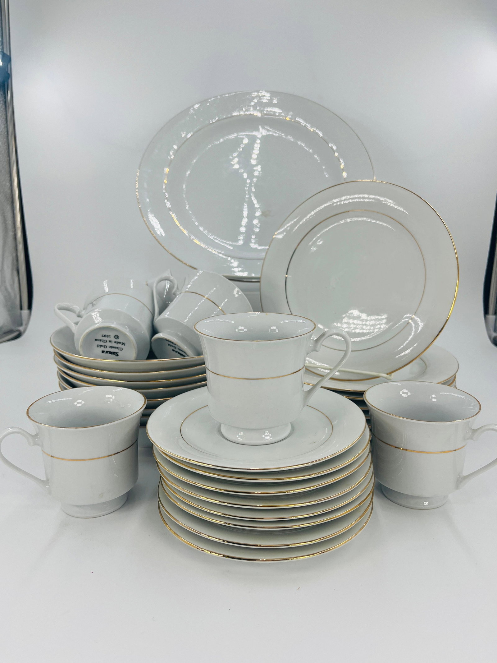 Sakura Servingware, INV. 1129: Includes 1 large plate, 8 small plates, 8 bowls, 8 saucers, 6 cups. Largest plate dia. 12 3/8". With marking.