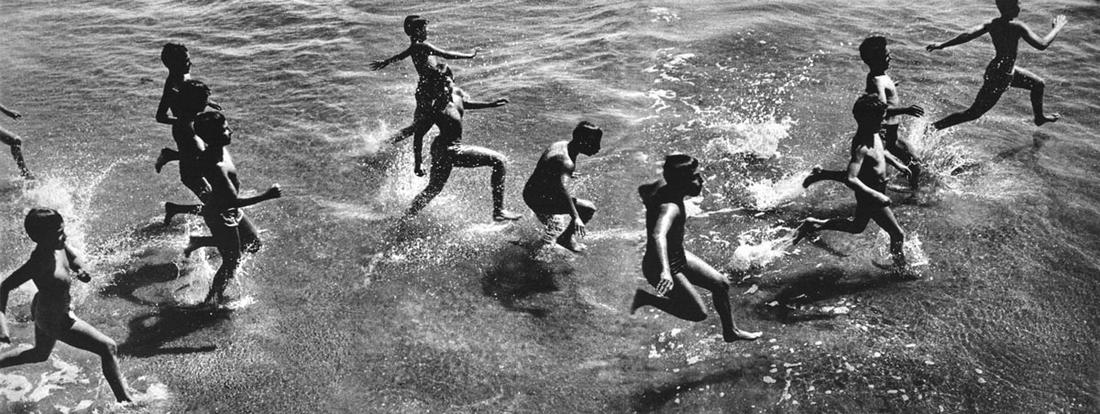 Harold Feinstein: Boys Running into Surf: Harold Feinstein: Boys Running into Surf, 1954/c. 1970, silver print on Portrtiga paper, signed recto, Image size: 3.5"x9"; Sheet Size: 11"x14". This image is one of Feinstein's iconic montages made f