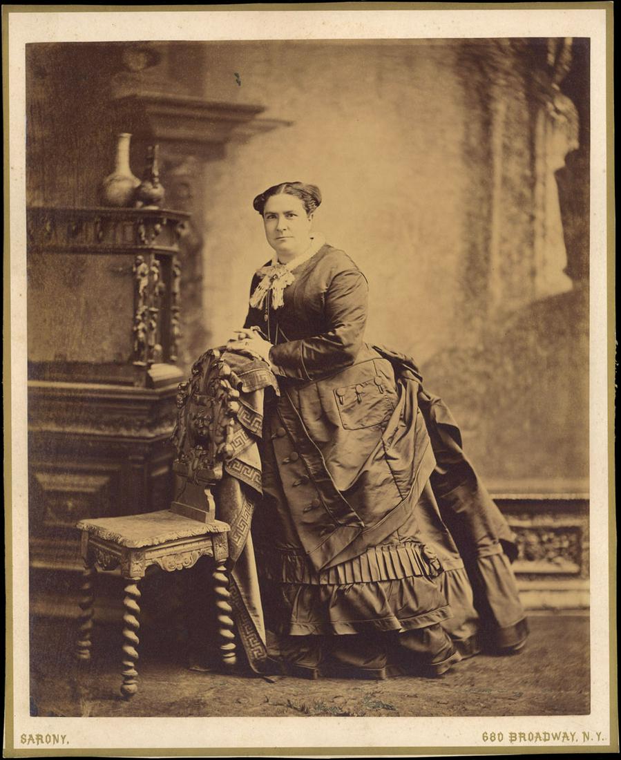Napoleon Sarony: Portrait of an impressive woman in an: Napoleon Sarony: Portrait of an impressive woman in an impressive dress, 1880s–90s, mammoth albumen print, name and studio address printed on mount, Image size: 15.625"x13.125"; Sheet Size: 17.3
